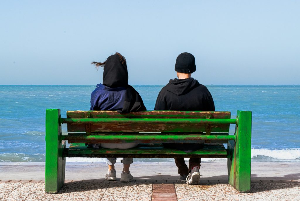 stock photo, Bushehr, Bushehr Province, Iran, two people on bench, woman, man